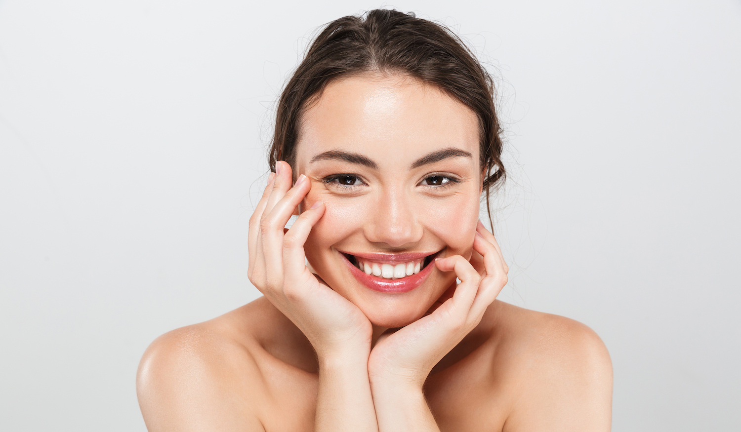 Beauty portrait of a smiling young topless woman